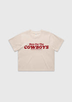 Bone cropped t-shirt with bold red “Here For The Cowboys” Western graphic, structured boxy fit, heavy cotton fabric, America Provisions apparel product photo on a neutral background.