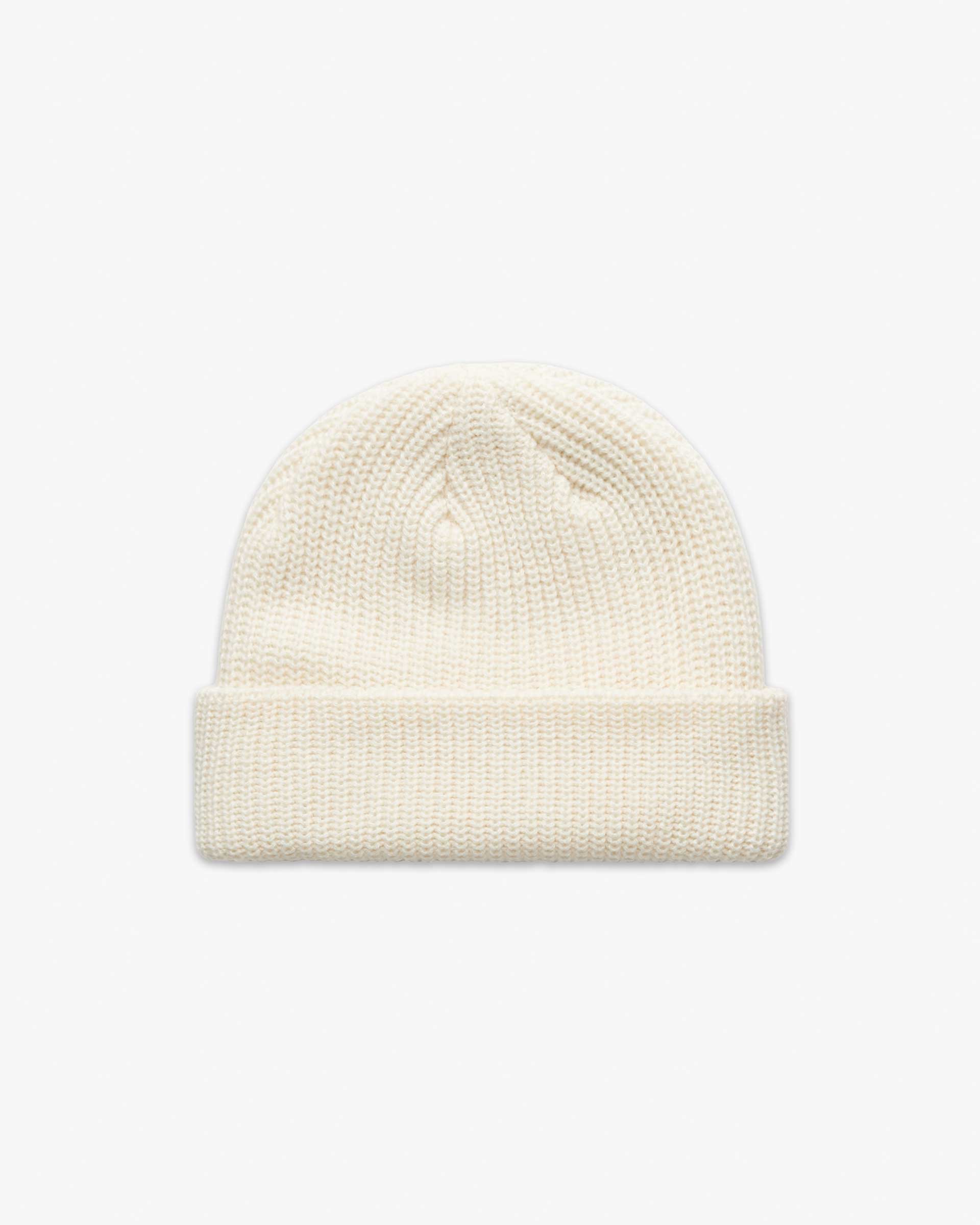 Ecru Short fisherman-style beanie with wide ribbed knit displayed flat for product detail.