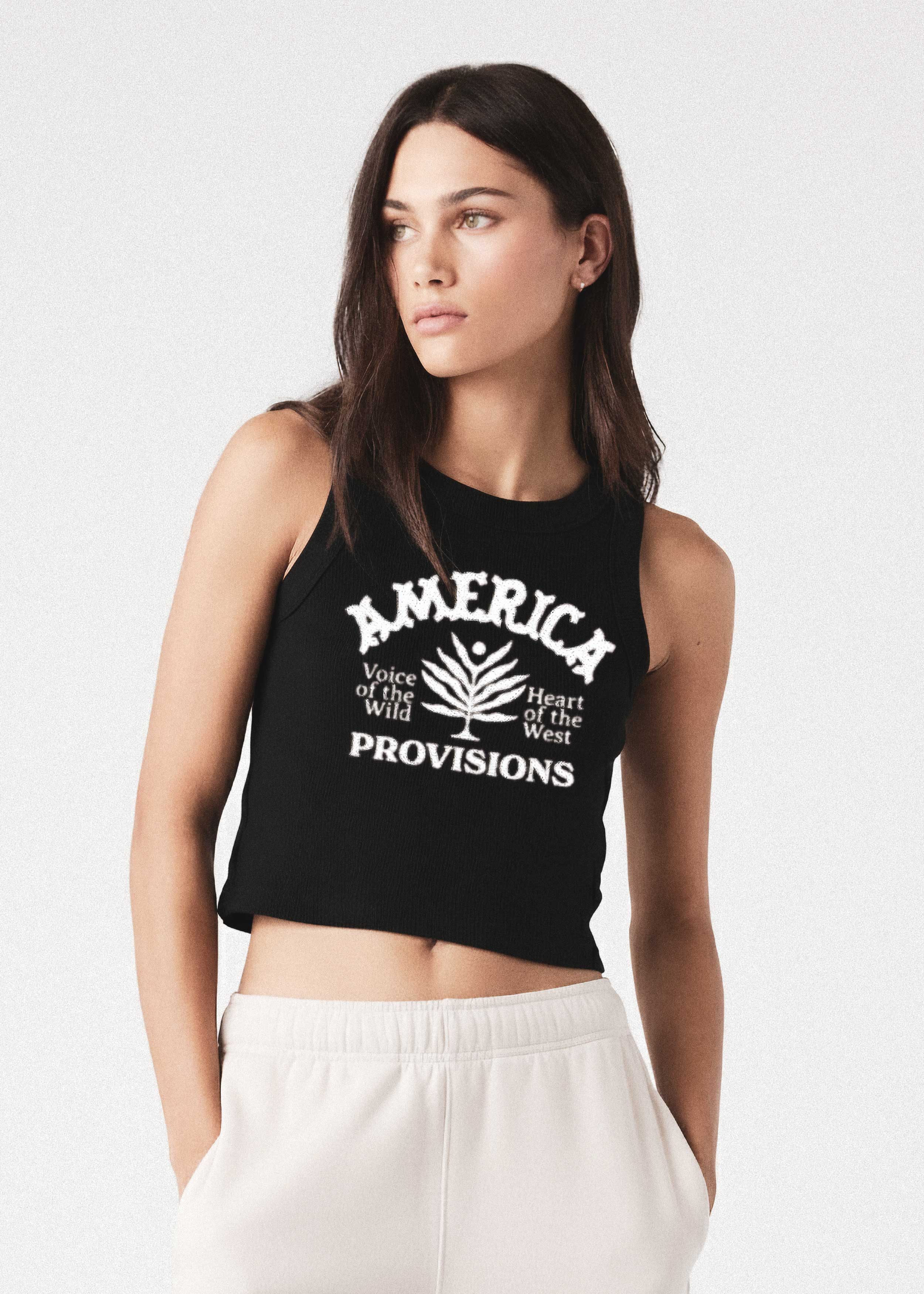 Woman wearing a black tank top with 'America Provisions' branding on a white background