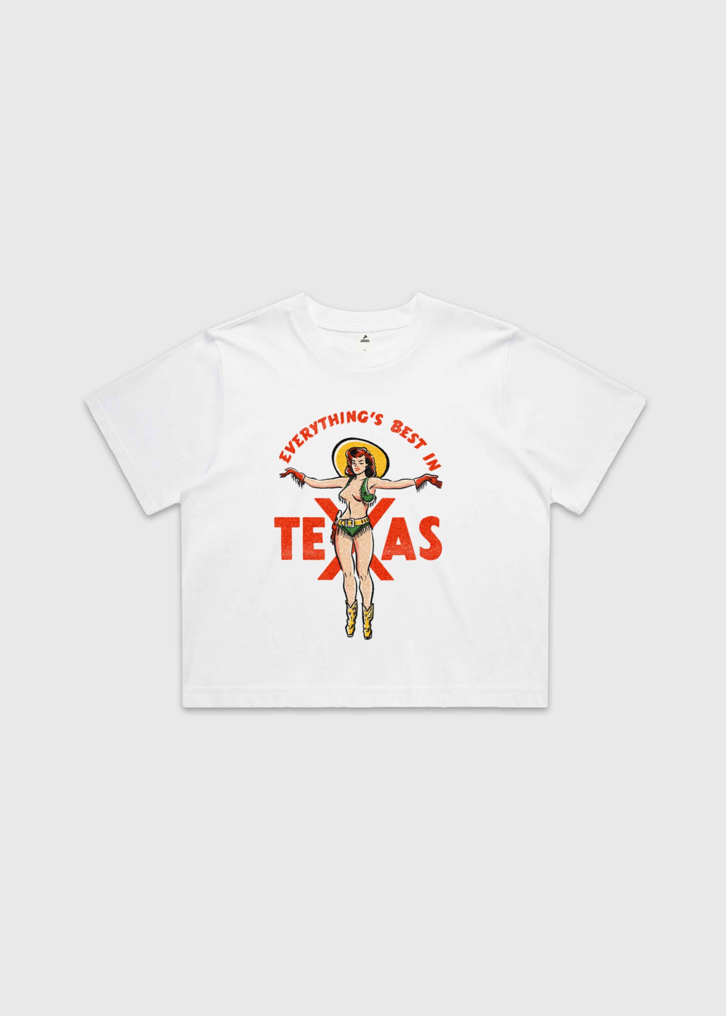White cropped t-shirt featuring a retro cowgirl illustration with the text “Everything’s Best in Texas,” premium Western graphic tee by America Provisions.