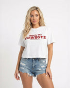 Model wearing White cropped t-shirt with bold red “Here For The Cowboys” Western graphic, structured boxy fit, heavy cotton fabric, America Provisions apparel product photo on a neutral background.