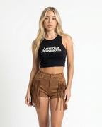 Black crop top with America Provisions logo on. Blonde model is wearing the crop top and denim shorts