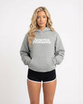 Woman wearing a gray hoodie with 'America Provisions' text on a white background