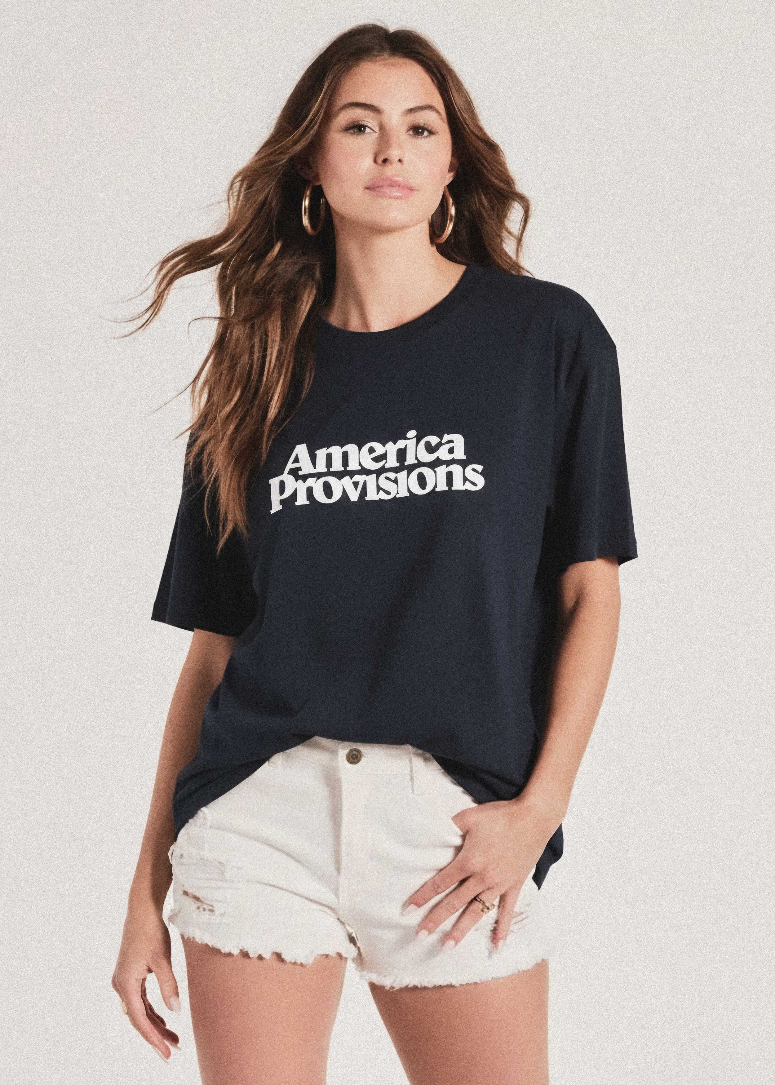 Woman wearing a black t-shirt with 'America Provisions' text on a white background