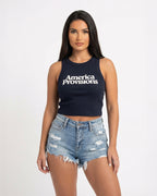 Navy crop top with America Provisions logo on. Blonde model is wearing the crop top and denim shorts
