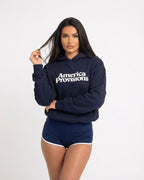 Woman wearing a navy blue hoodie with 'America Provisions' text on a white background