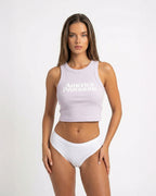 Orchid crop top with America Provisions logo on. Blonde model is wearing the crop top and denim shorts