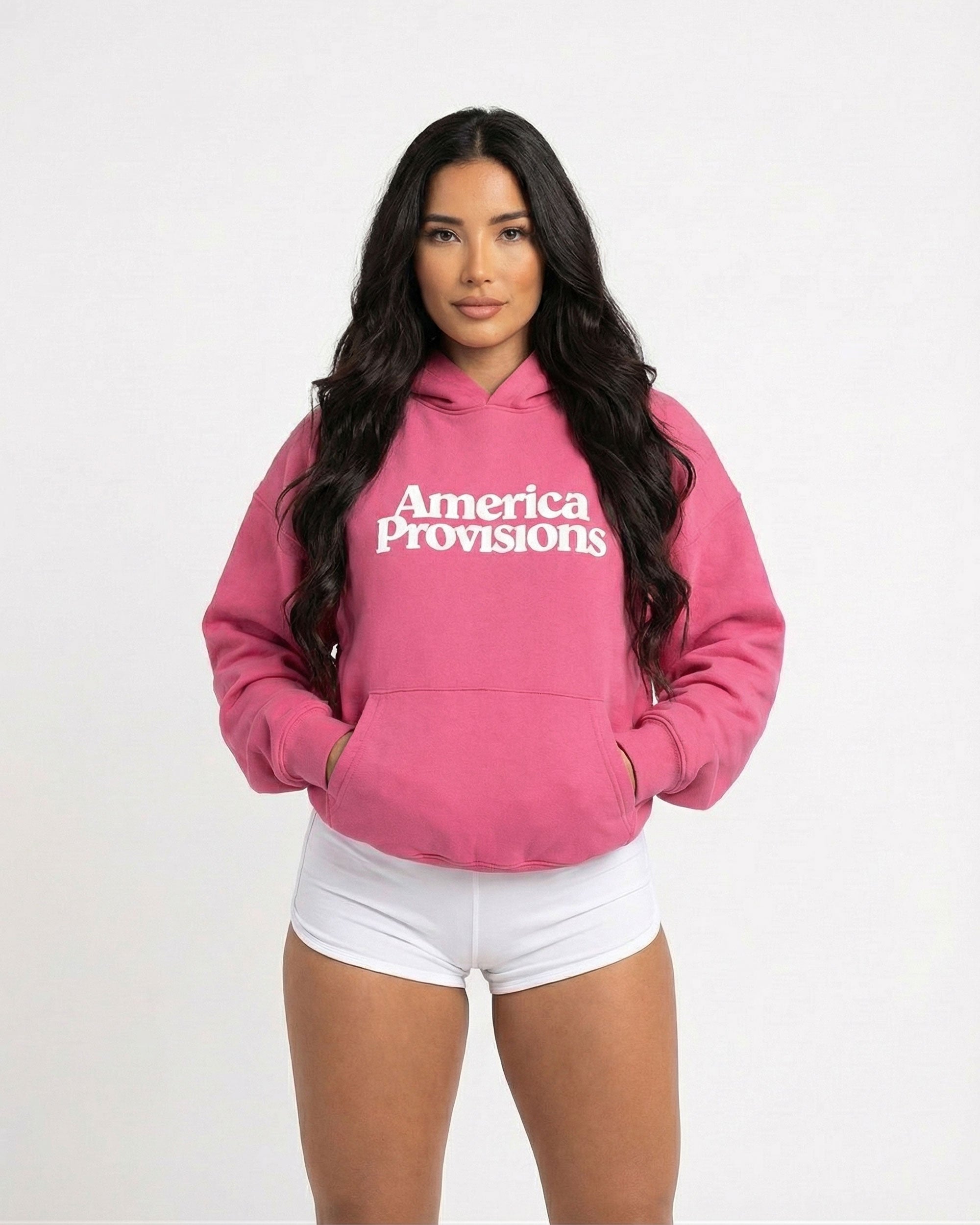 Woman wearing a Pink hoodie with 'America Provisions' text on a white background
