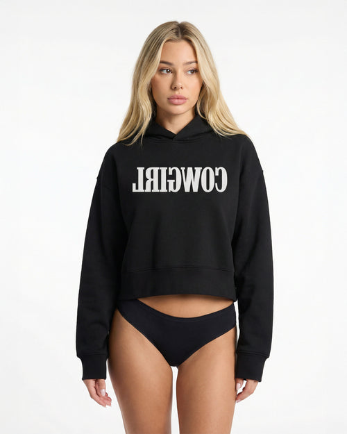 Reverse Cowgirl Woman wearing a cropped black hoodie with 'COWIRL' text on a white background