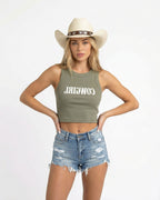 Woman wearing a eucalyptus crop top with red text saying Cowgirl backwards and red high-waisted bikini bottoms on a white background