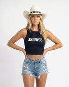Woman wearing a navy crop top with red text saying Cowgirl backwards and red high-waisted bikini bottoms on a white background