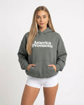 Woman wearing a Gray hoodie with 'America Provisions' text on a white background