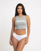 Storm gray crop top with America Provisions logo on. Blonde model is wearing the crop top and denim shorts